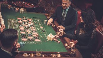 People betting at a Roulette table in a casino