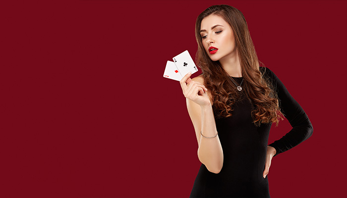 Woman holding a pair of aces