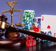 An image of a gavel next to dice, playing cards, and casino tokens