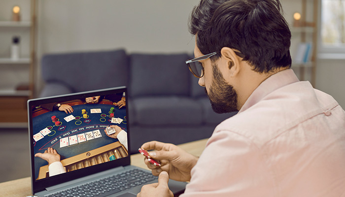 Poker Player Sat at Computer