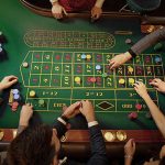Gambler Placing Bets at Roulette Table in Casino
