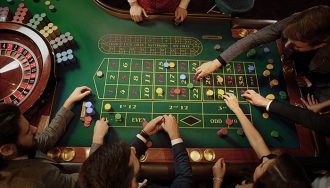 Gambler Placing Bets at Roulette Table in Casino