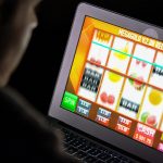 Gambler Playing Slots at Online Casino Using Computer