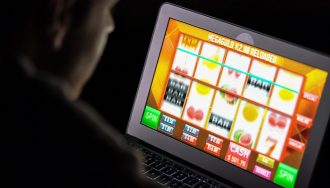 Gambler Playing Slots at Online Casino Using Computer