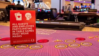 A Sign on a Casino Table Initiating Masks for Everybody Indoors