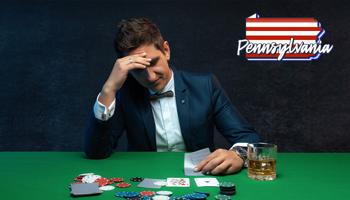 Pennsylvania Logo next to a Player on a Poker Table