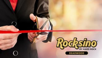 Rocksino By Hard Rock Logo Next to a Person in a Suit Cutting Red Ribbon with Scissors