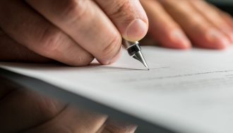 A Person Signing Documents