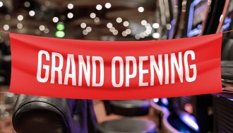 Sign Grand Opening with White Letters on a Red Sign over Blurred Casino Hall