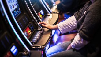 Gambler Playing Slot in Casino